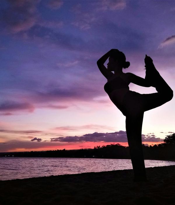 Woman in a graceful yoga pose, finding balance and tranquility.